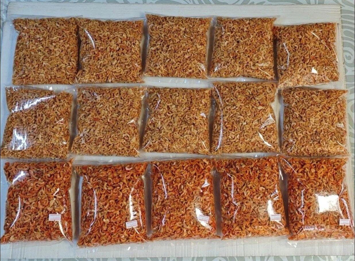 Fifteen sealed bags of dried shrimp laid out in rows